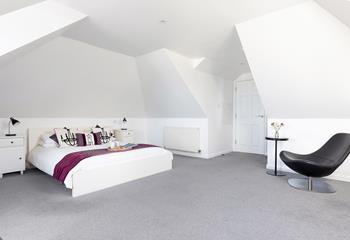 The king-sized bed is the perfect spot to enjoy a slow, peaceful morning. 