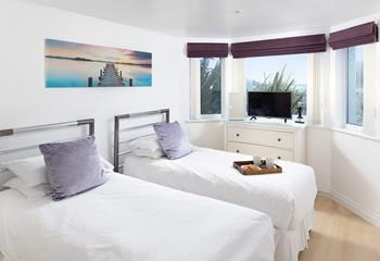 Slide into the sheets in bedroom 1 after a day of adventure.